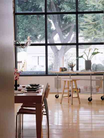 An abundance of natural light makes the main room an ideal spot for Claudio to work on his paintings. The huge south-facing window is also a natural passive solar collector. Designer John Picard installed light-toned bamboo flooring for environmental reasons (it matures quickly and grows like a weed), but Jana loves its durability and low maintenance. “We had a Christmas tree whose container leaked for three days before we discovered the problem,” she recalls.